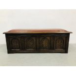 A REPRODUCTION BASKET BOX WITH FOUR CARVED PANELS AND LEATHER CUSHIONED SEAT TO TOP. L 140CM.