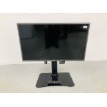 AN LG 32 INCH FLAT SCREEN TELEVISION ON IN VISION STAND WITH REMOTE CONTROL - SOLD AS SEEN