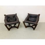 A PAIR OF DESIGNER EASY CHAIRS WITH LEATHER SEATS