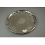 A circular salver, with raised beaded border, flat chased to centre, Birmingham 1972, 31cm diameter,