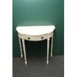 A white painted break bow fronted console table fitted with two drawers on square tapering fluted