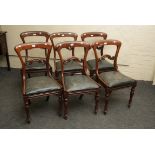 A set of six early Victorian figural mahogany dining chairs, with shaped cresting rails, drop in