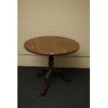 A George III mahogany circular tripod table, with urn and barrel column, 87cm diameter