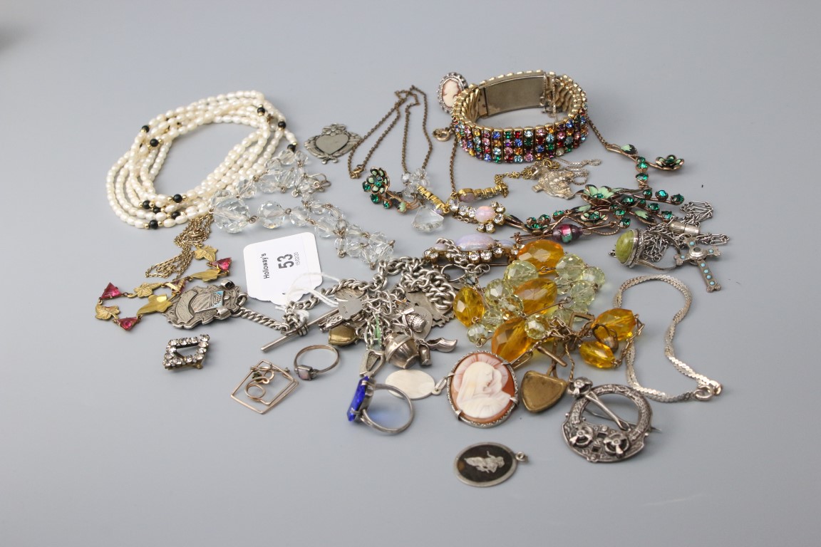 A silver curb pattern watch chain, with two suspended medals, a silver charm bracelet and a quantity