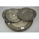 A collection of antique pewter chargers and tavern plates