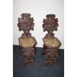 A pair of Victorian Tyrollian style oak hall chairs with deep carved decoration