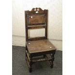 An early 18th century oak regional back stool, with panel back