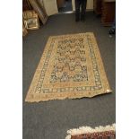 An early 20th century Egyptian blue ground rug with stylized flowers within a pin wheel border,