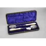 A pair of Edwardian ivory handled EPNS salad servers, presentation boxed