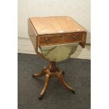 An early 19th century rosewood crossbanded mahogany two flap work table, with lunette bag, raised on