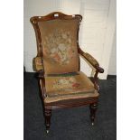 A 19th century Indian rosewood open armchair, with scroll arms and needlework upholstery fitted W