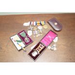 A World War One Military Cross four medal group, and corresponding miniature medals sets, cased