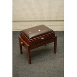 An adjustable height piano stool with leatherette top and mahogany frame, 55cm wide