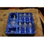 A presentation boxed cut crystal decanter and six stemmed wine glasses