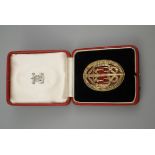 Cased silver gilt oval badge