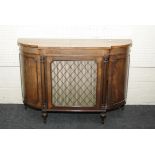 A Regency style mahogany chiffonier, with bow end cupboards and canted brass and silk cupboard,