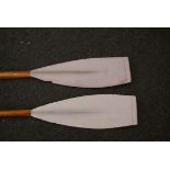 A pair of vintage E Ayling Rowing Club oars with white painted blades (Durham University Rowing Club