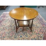 A late Victorian walnut circular centre table with undertier and spindle supports, 92cm diameter