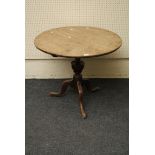 A George III oak circular snap top wine table with vase stem and tripod base, 83cm diameter