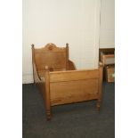 A 19th century French stripped and waxed single bed, with moulded appliques and shaped ends, 100cm