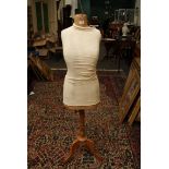 A 'French Bust' dress makers mannequin on an adjustable tripod base