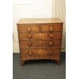 A George III oak chest of two over three long drawers, raised on bucket support, 94cm