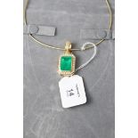 A substantial emerald and diamond pendant, the step cut, cut, cornered emerald in rub over mount,