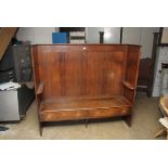 A George III oak curved high backed settle with enclosed shaped arms, fitted drawers below the seat,