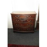 An early 19th century mahogany bow fronted chest of drawers fitted two short over three long drawers