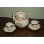 An early 19th century Paris Porcelain part tea set with entwined gilt monogram on a white ground