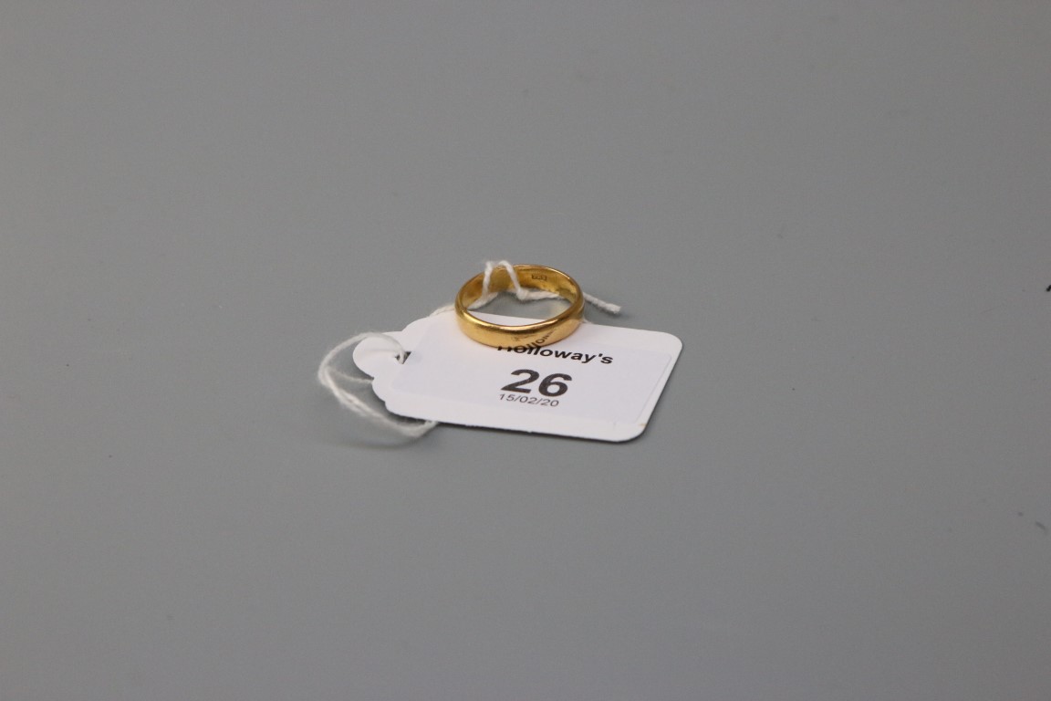 A wedding band, marked '22ct', polished 'D' profile Ring size O, 4.1g