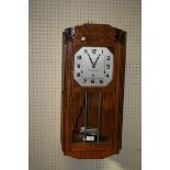 An oak cased Westminster chiming Art Deco wall clock. 68cm long