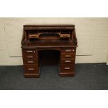 A 19th century oak 'S' shaped roll top desk, with twin pedestals, 122cm long