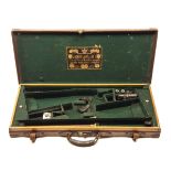 JOSEPH LANG & SON LTD. A BRASS-CORNERED OAK AND LEATHER DOUBLE GUNCASE, fitted for 28in. barrels,