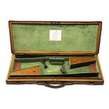 A BRASS-CORNERED OAK AND LEATHER DOUBLE GUNCASE, fitted for 30in. barrels, the interior re-lined