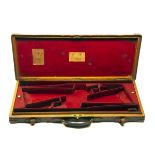 JAMES PURDEY & SONS A BRASS-CORNERED OAK AND LEATHER DOUBLE GUNCASE, fitted for 30in. barrels, the