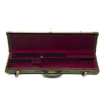 A BROWN LEATHER SINGLE GUNCASE, fitted for 28in. barrels, the interior lined with maroon baize,