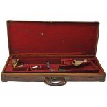 A BRASS-CORNERED OAK AND LEATHER DOUBLE GUNCASE, fitted for 30in. barrels, the interior lined with