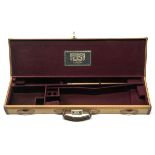 A CANVAS AND LEATHER SINGLE GUNCASE, fitted for 28in. barrels, the interior lined with maroon baize,