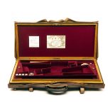 JAMES PURDEY & SONS A BRASS-CORNERED OAK AND LEATHER DOUBLE GUNCASE, fitted for 28in. barrels, the