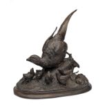 A BRONZE OF A FEMALE PHEASANT WITH SIX CHICKS, with an oval base, measuring approx. 18in. x 17in.