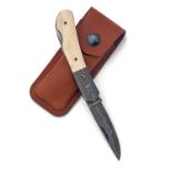 JAMES PURDEY & SONS A FINE DAMASCUS STEEL AND MAMMOTH TUSK FOLDING KNIFE, with 2 1/2in. drop point