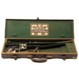 JOSEPH LANG & SON LTD. A BRASS-CORNERED OAK AND LEATHER SINGLE GUNCASE, fitted for 28in. barrels,