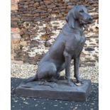A LIFE SIZE CAST IRON HOUND, in a sitting position on a rectangle base, measuring approx. 31in.