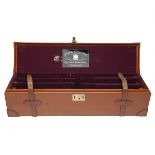 A TAN LEATHER TRIPLE GUNCASE, fitted for 28in. barrels, the interior lined with maroon baize, a