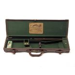 W. RICHARDS A LEATHER SINGLE GUNCASE, fitted for 30in. barrels, the interior lined with green baize,