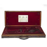 STEPHEN GRANT & SONS A BRASS-CORNERED OAK AND LEATHER DOUBLE GUNCASE, fitted for 29in. barrels (