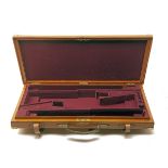 A BRASS-CORNERED OAK AND LEATHER UNIVERSAL DOUBLE GUNCASE, fitted for 30in. barrels, the interior