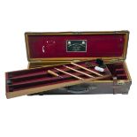 JAMES PURDEY & SONS A BRASS-MOUNTED OAK AND LEATHER TRIPLE GUNCASE, fitted for 29in. barrels (