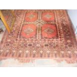 An antique Middle Eastern rug with geometric borde